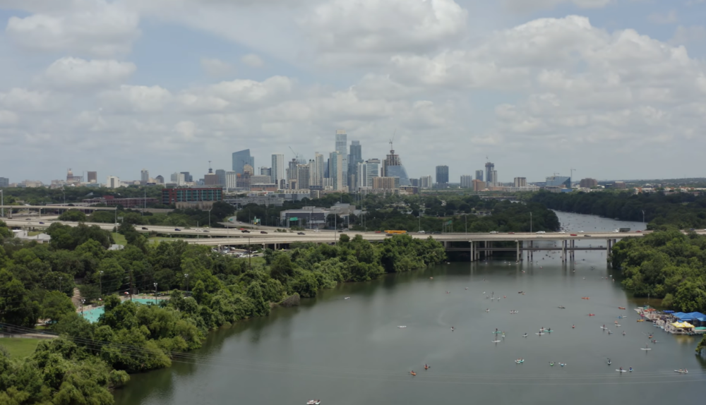 river, bridge over it, and the city on the horizon