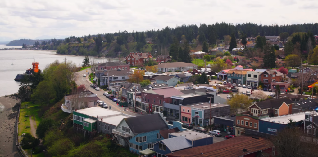 Aerial View of Colorful Houses Near the River with Trees