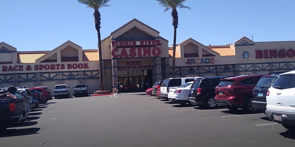 An image of a building with a casino hotel, arcade, bingo, and sportsbook as viewed from the parking area