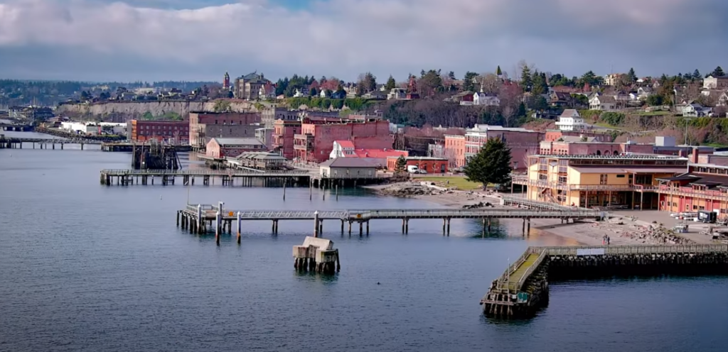 An image of a river with houses beside it and a bridge spanning across the water