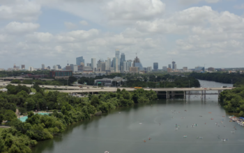 river, bridge over it, and the city on the horizon